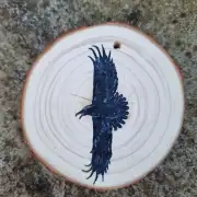 Raven on wood slice image 1