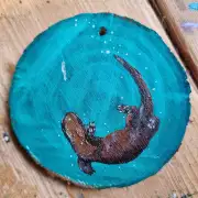 Otter on wood slice image 1