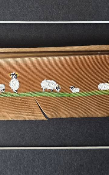 Flock of sheep painted on a peacock feather