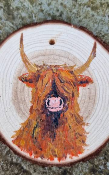 Heilan coo on wood slice