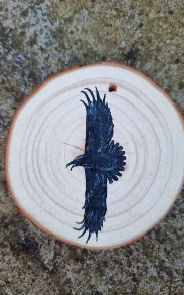 Raven on wood slice