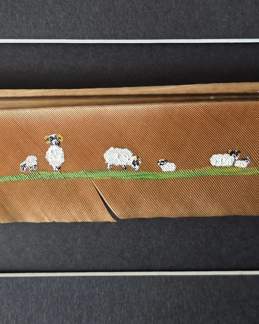 Flock of sheep painted on a peacock feather