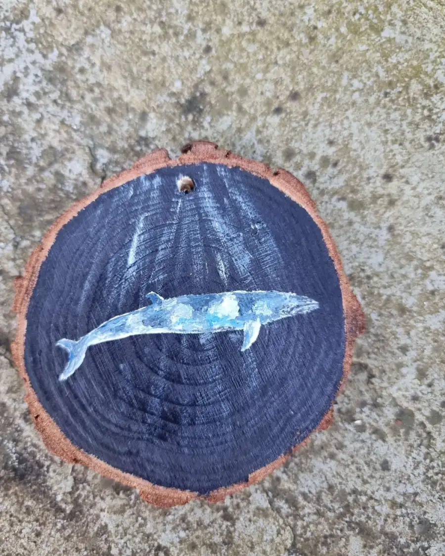 Minke whale on wood slice