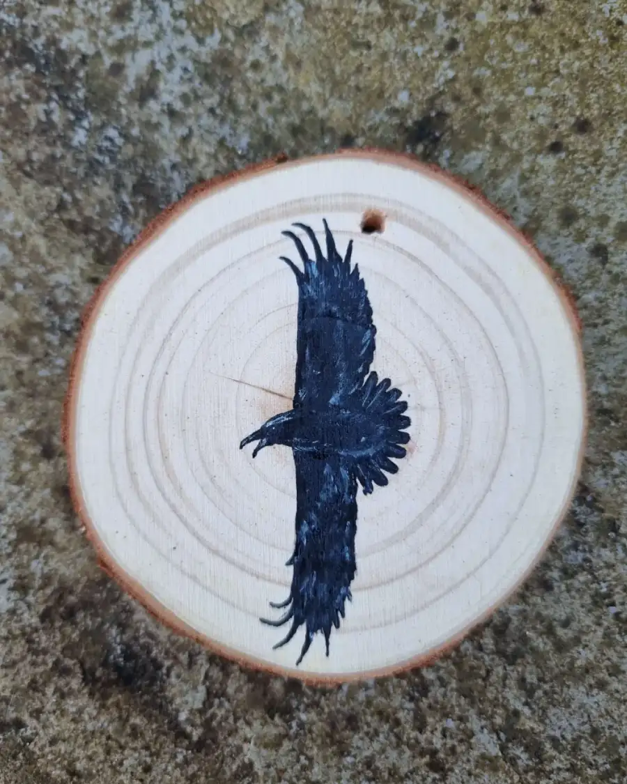 Raven on wood slice