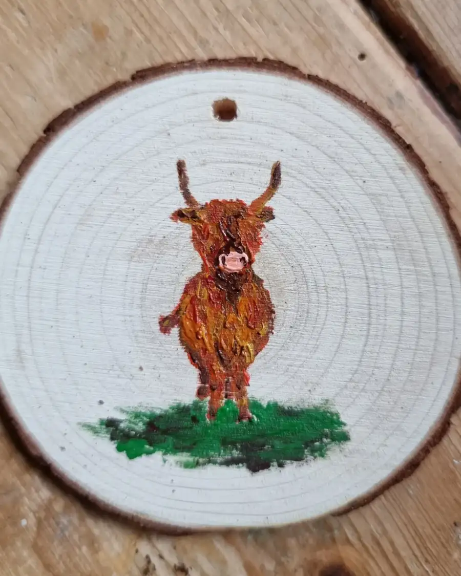 Heilan coo on wood slice