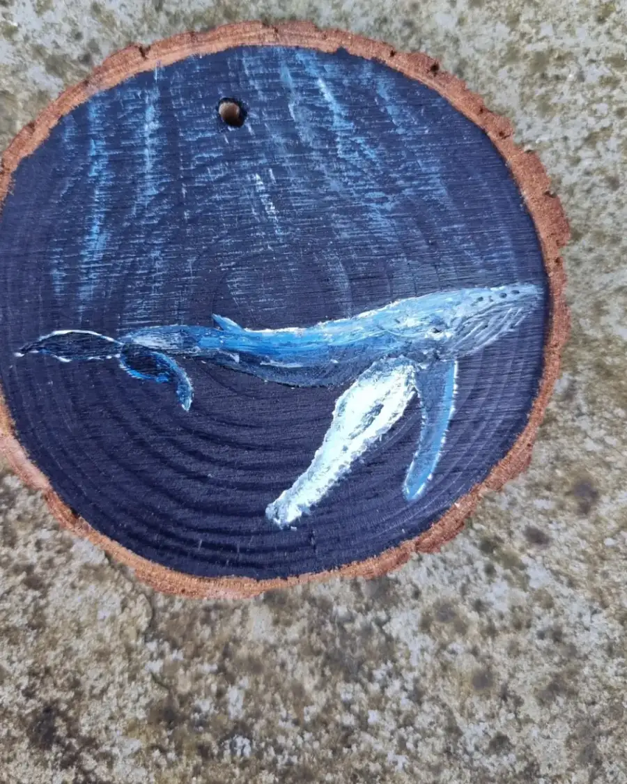 Humpback whale on wood slice