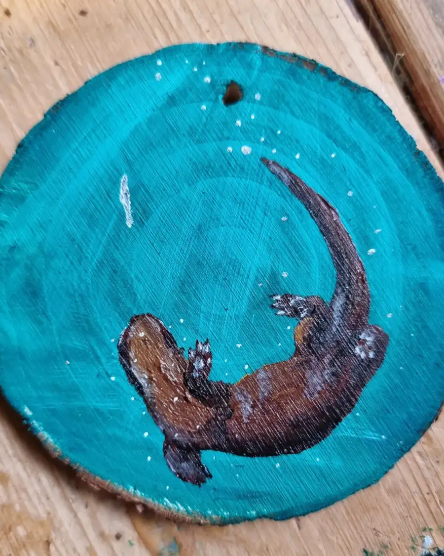 Otter on wood slice