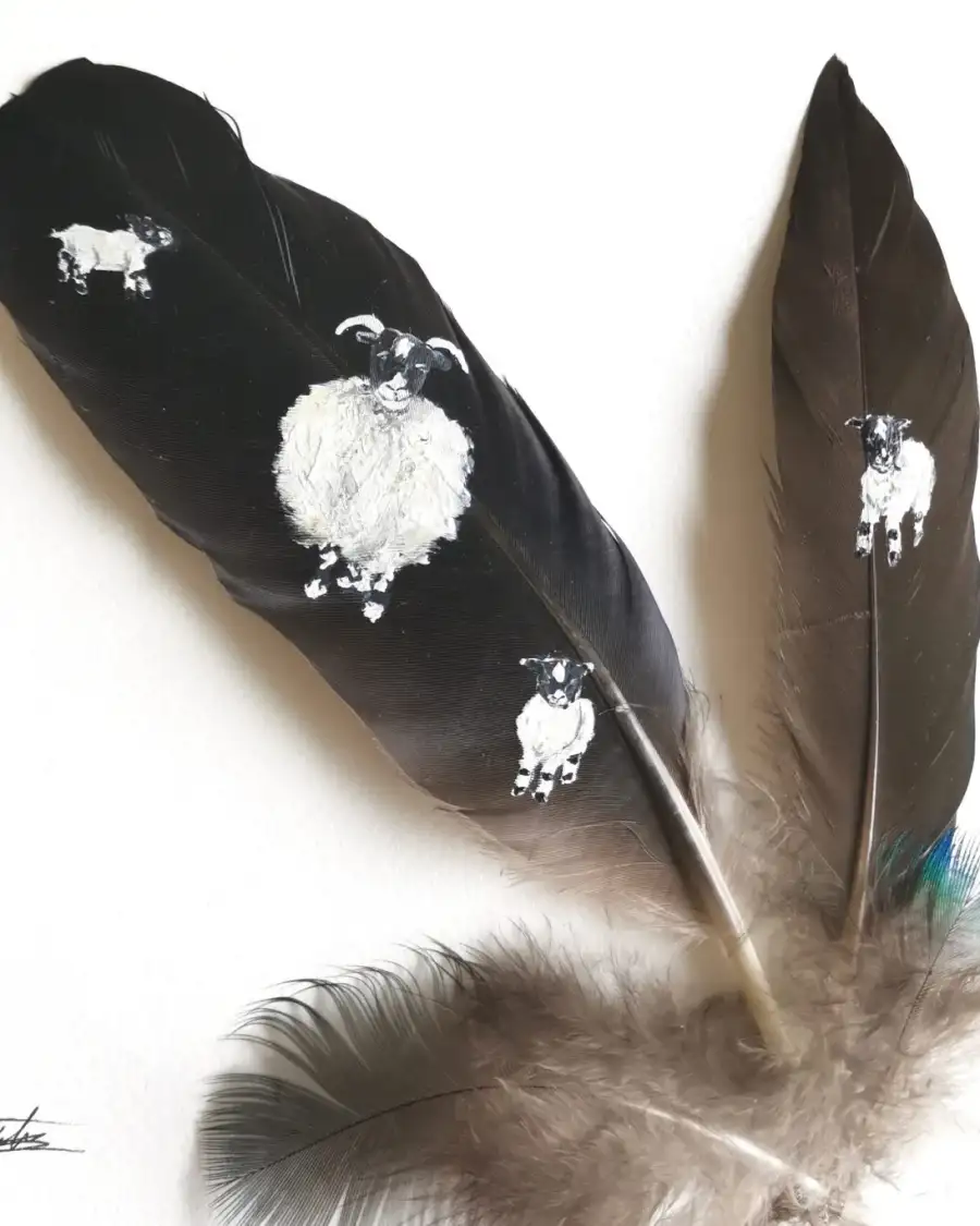 Sheep and lambs painted on raven and duck feathers